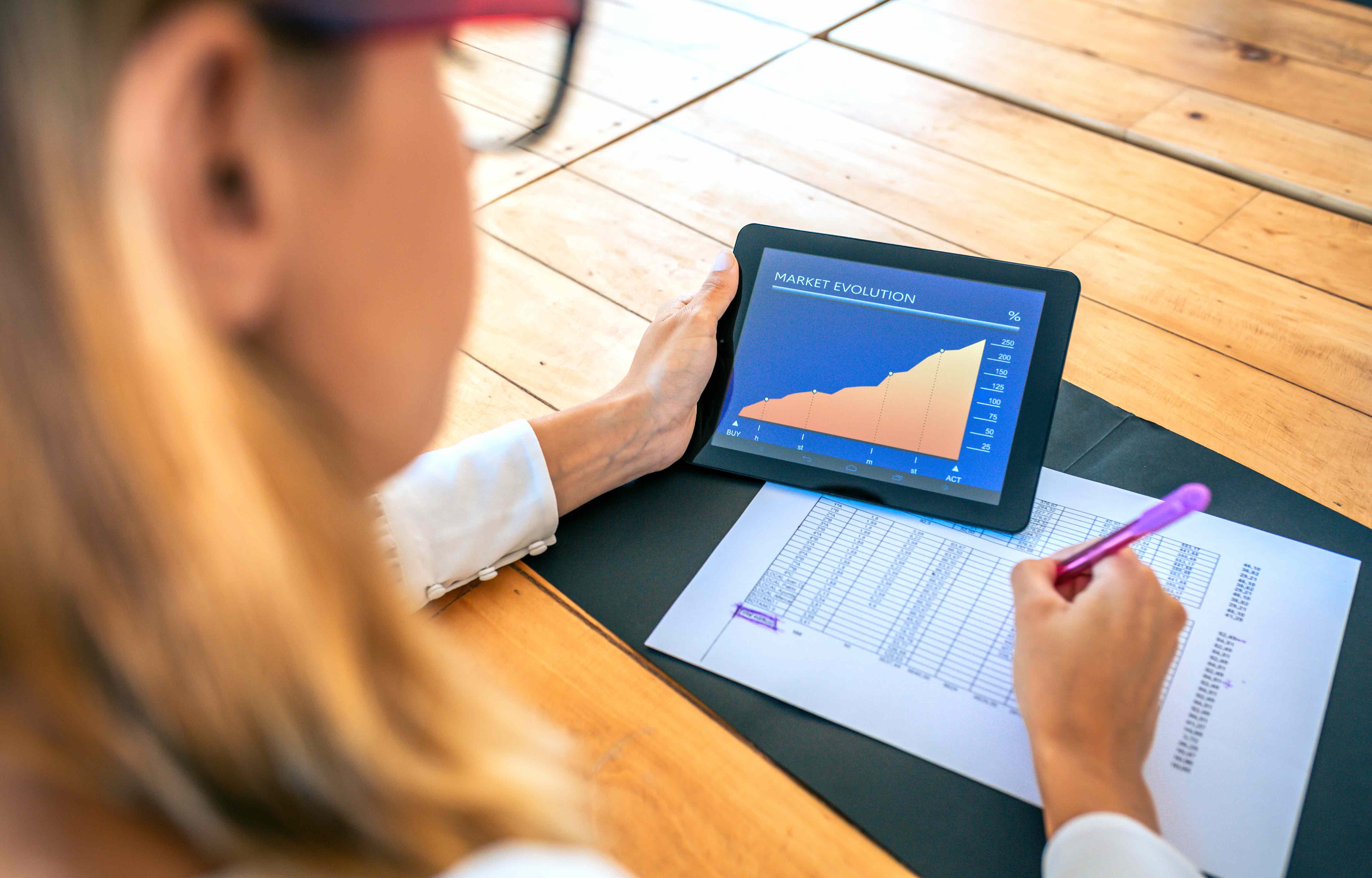 Businesswoman analyzing market evolution with a tablet