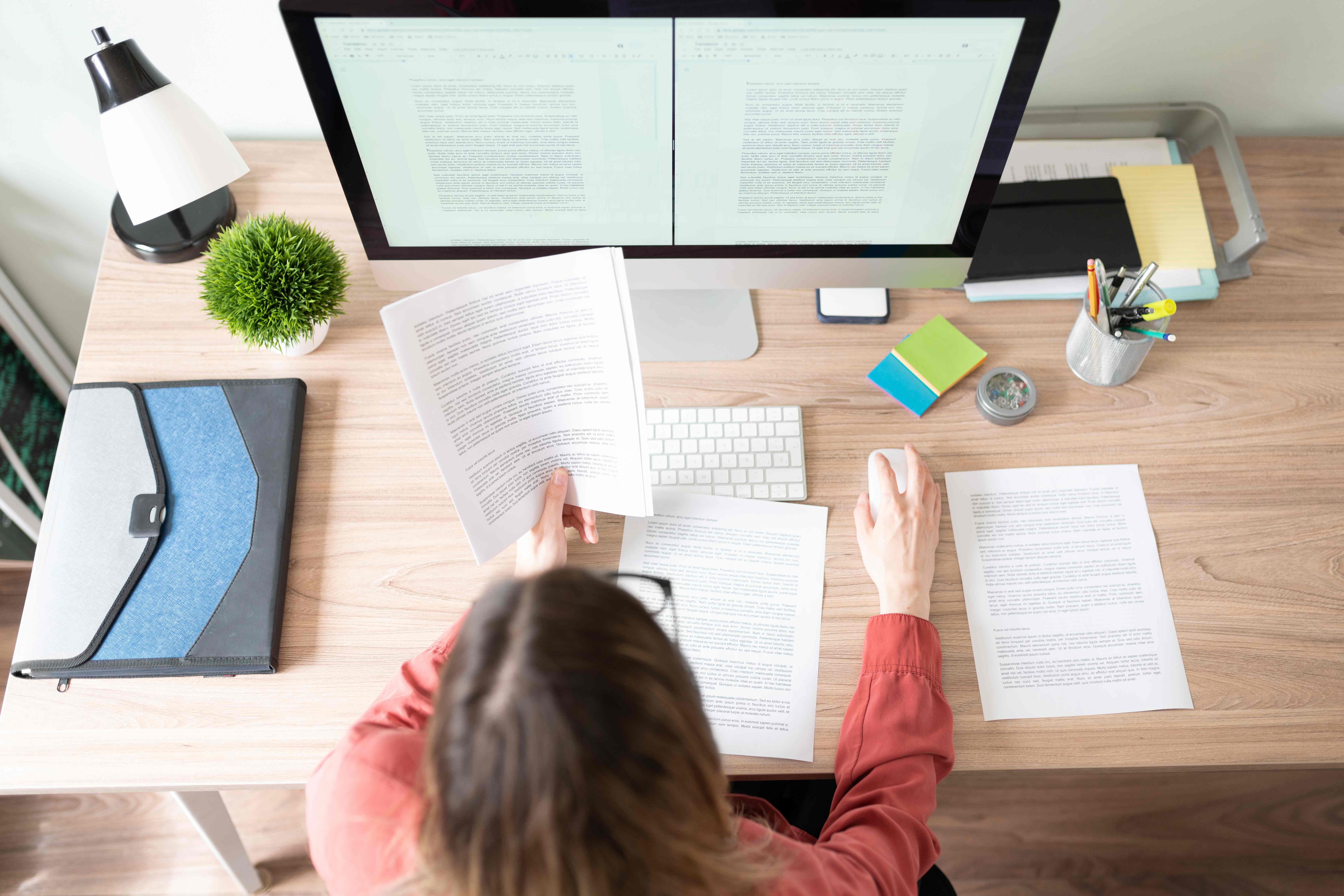 Female translator working on a document with a computer
